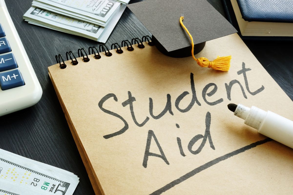 An image of a notebook with student aid written.