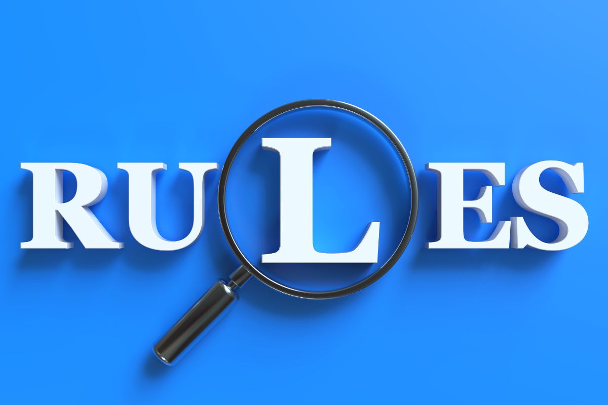 A picture of the rules wording with a magnifying glass.