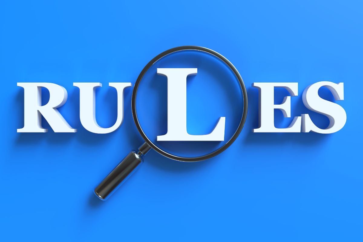 The photo shows letters and a magnifying glass focusing on one letter referring to the 1% rule focusing on making small that keeps things simple and realistic.