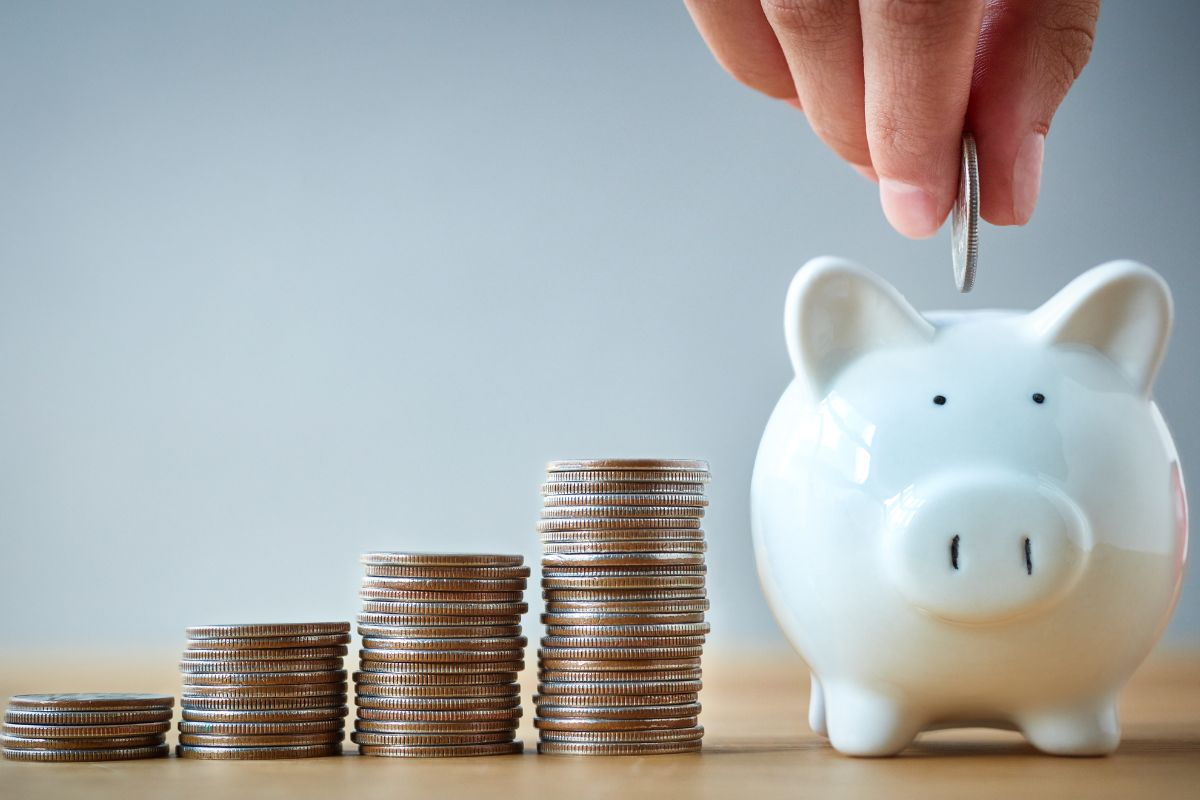 An image of a man's hand saving money.