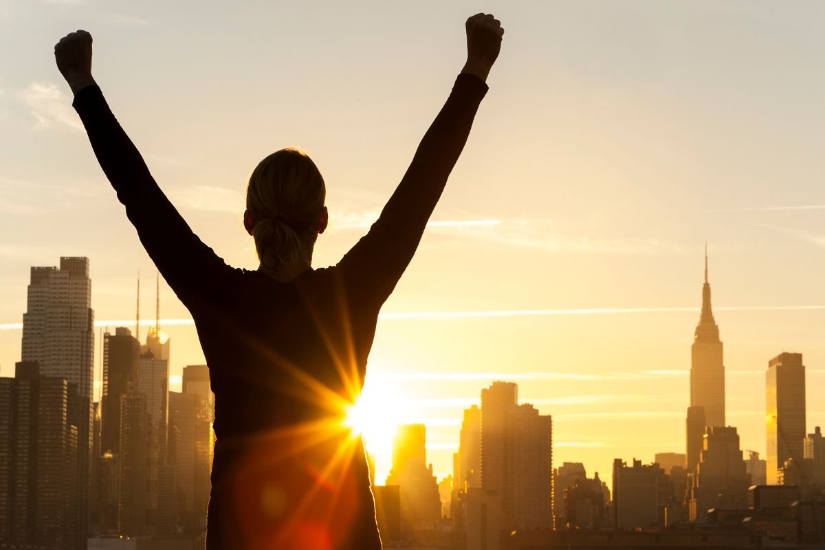 The picture shows a woman cheering for success.