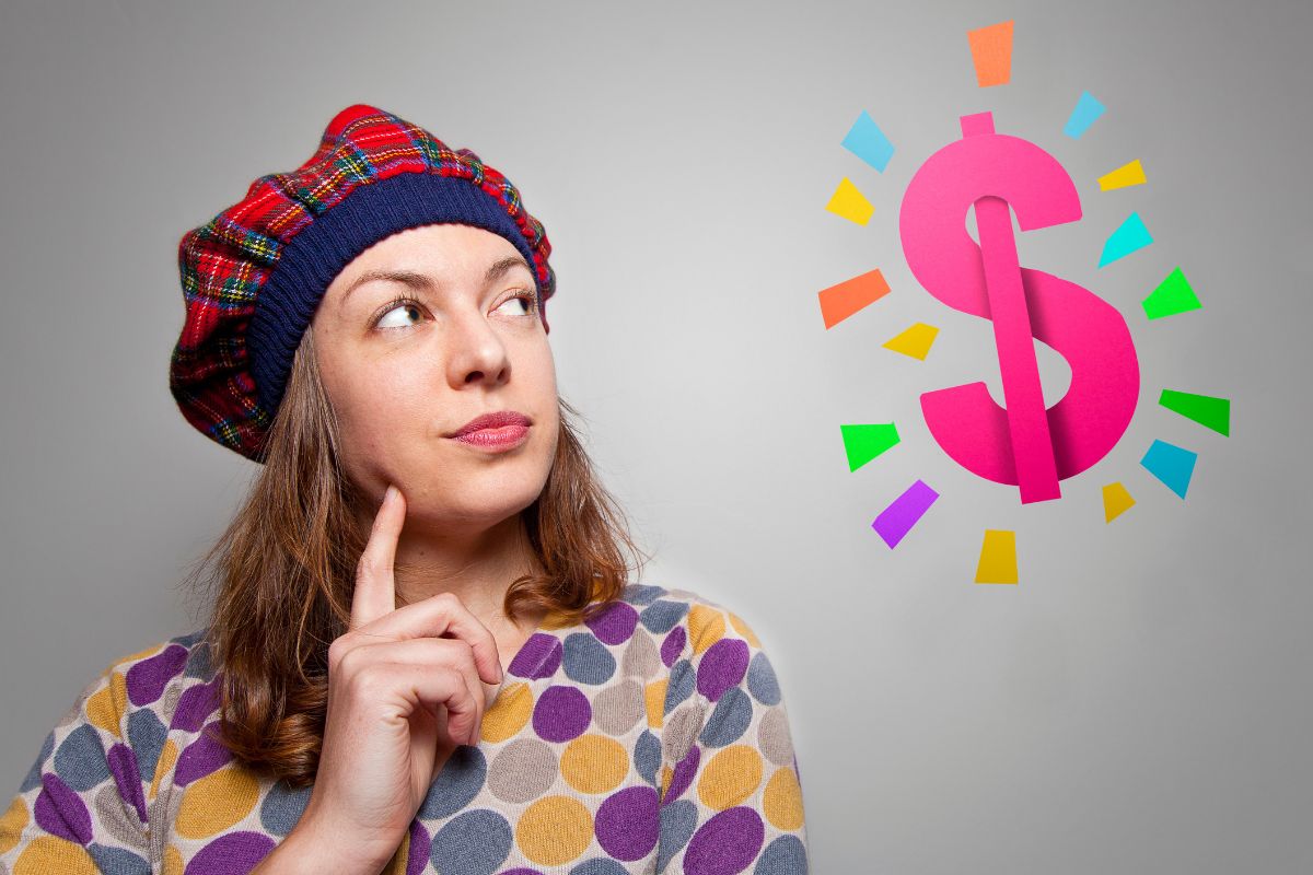 The picture of dollar sign and a girl thinking referring to release limiting beliefs about money and wealth is key to manifesting more money in your life.
