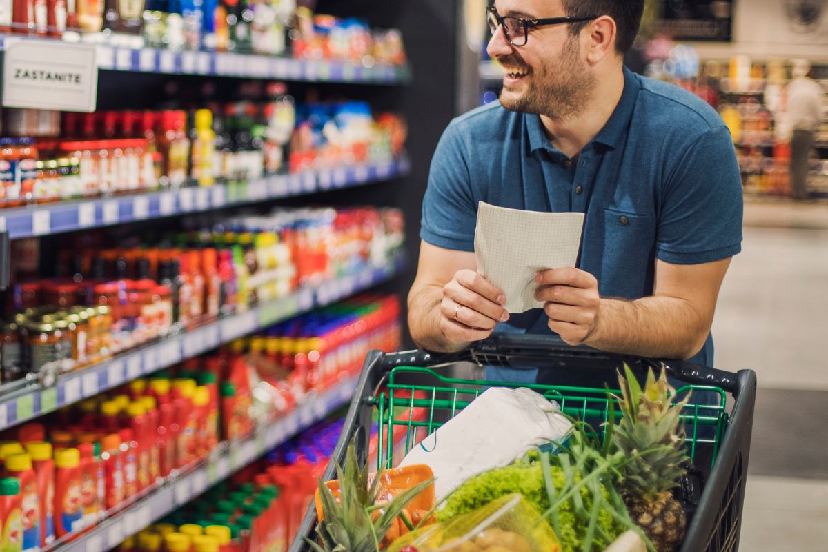 The image shows a man grocery shopping.