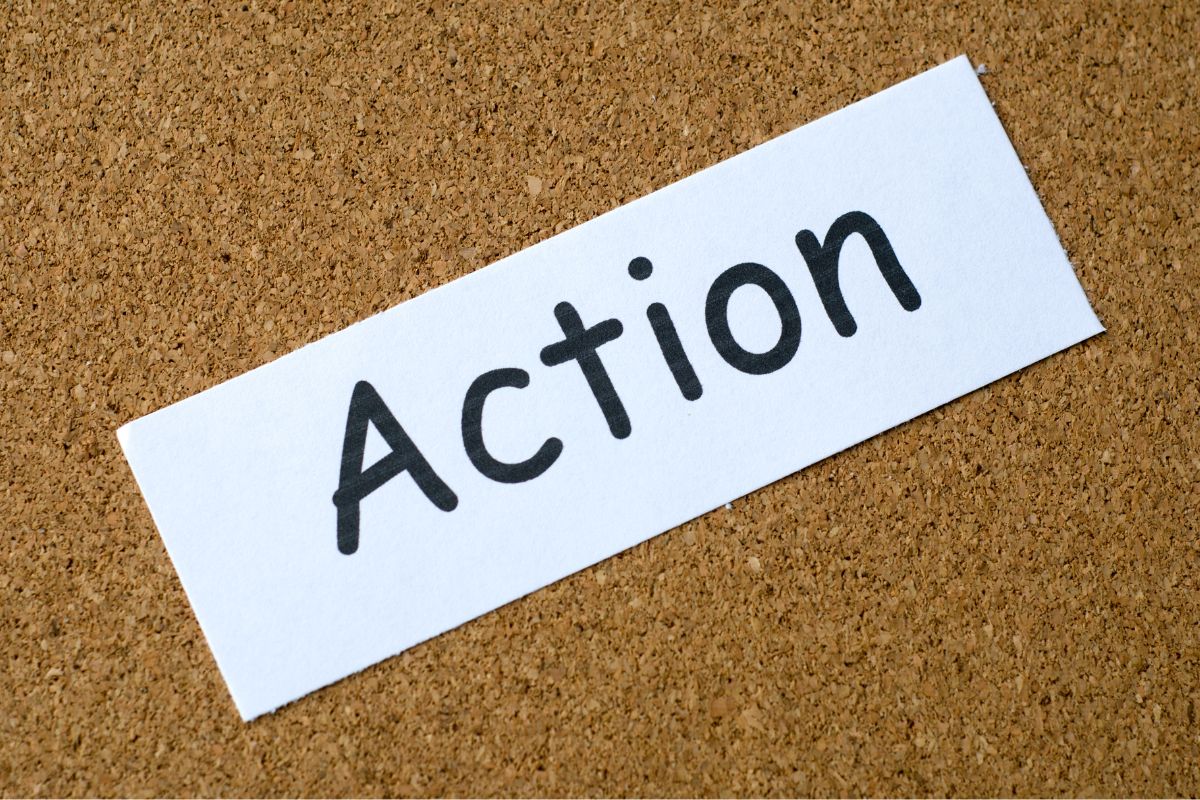 The photo shows a paper with action written on it.