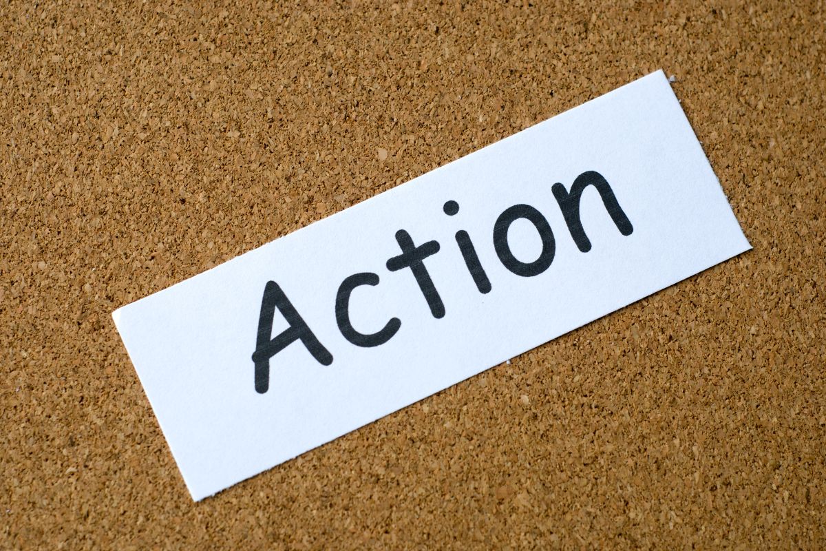 The image shows a piece of paper with a note that refers to aligning your actions with your financial intentions and money starts flowing in the right direction.