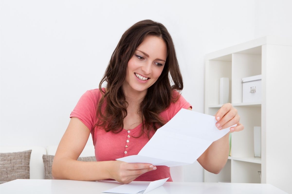 A photo of a woman repeating money mantras in the paper.