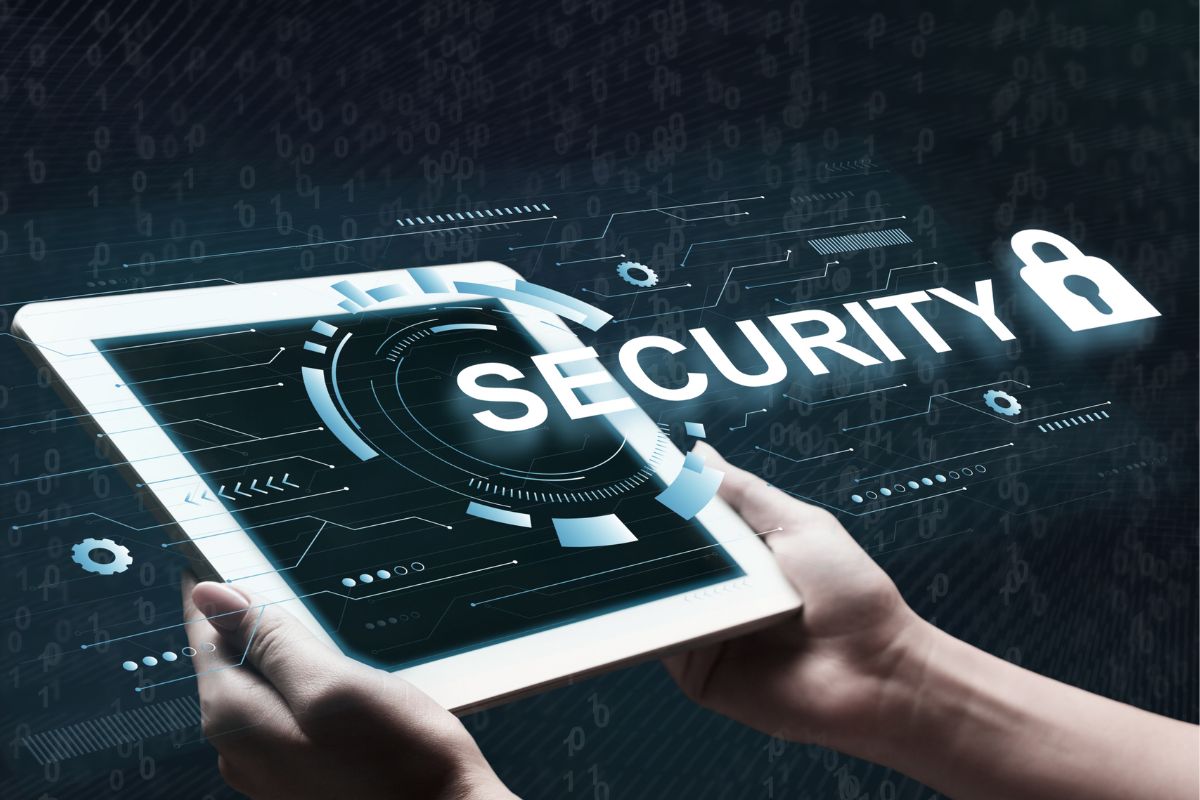 The picture shows a man's hand working on a cybersecurity analyst.
