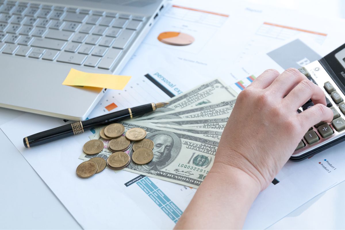 The photo of a woman's hand reviewing her financial goals.