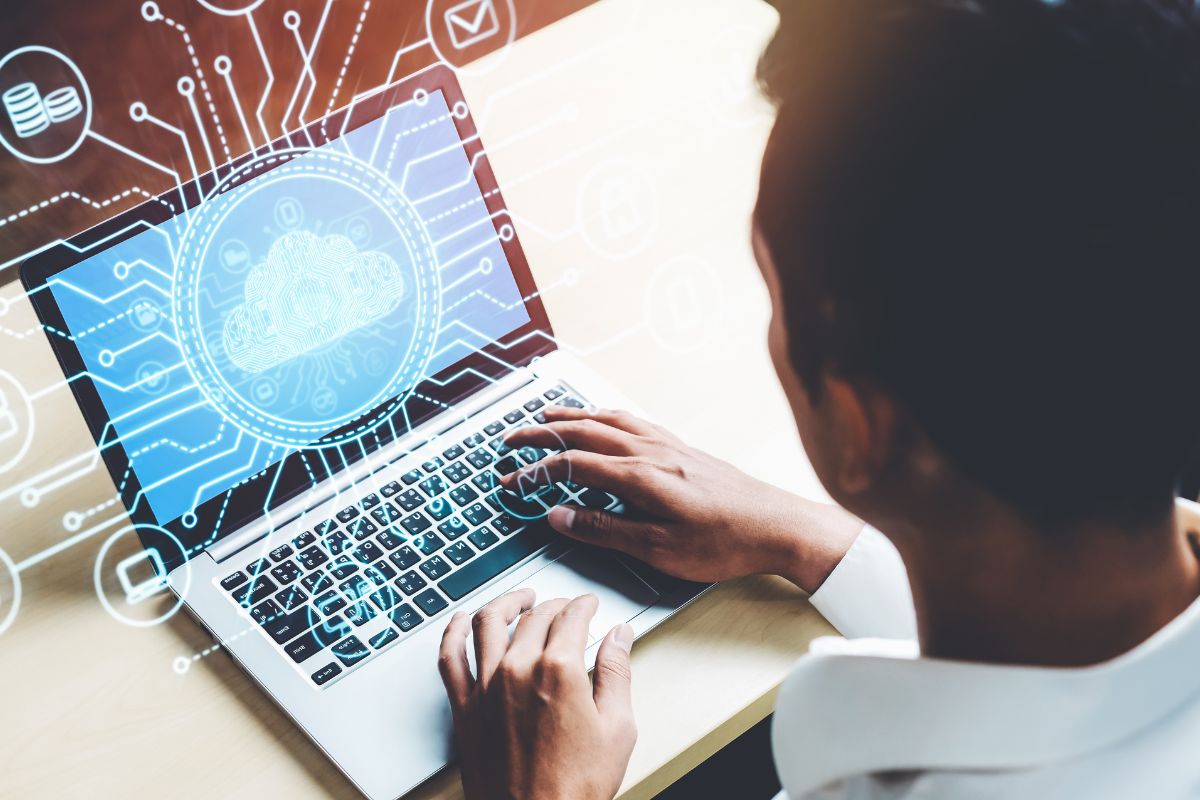 The picture shows a man working as a cloud engineer.