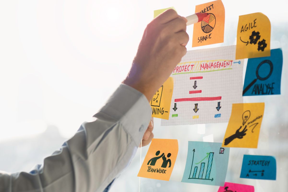 A picture shows a man's hand working as a project manager.