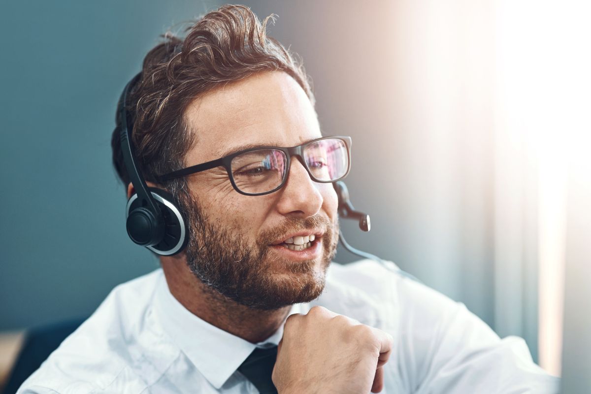 The image shows a man working as a business consultant.