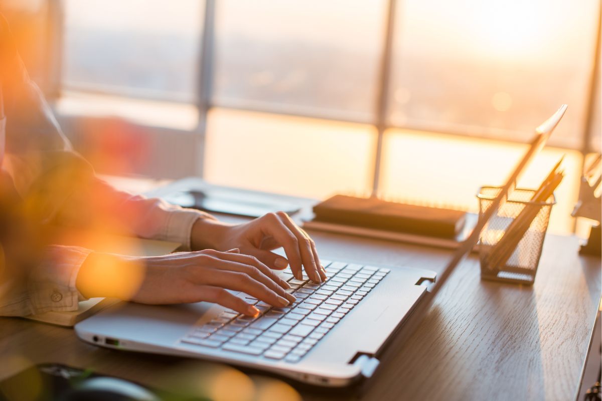 The photo shows a woman's hand working as a solutions architect.