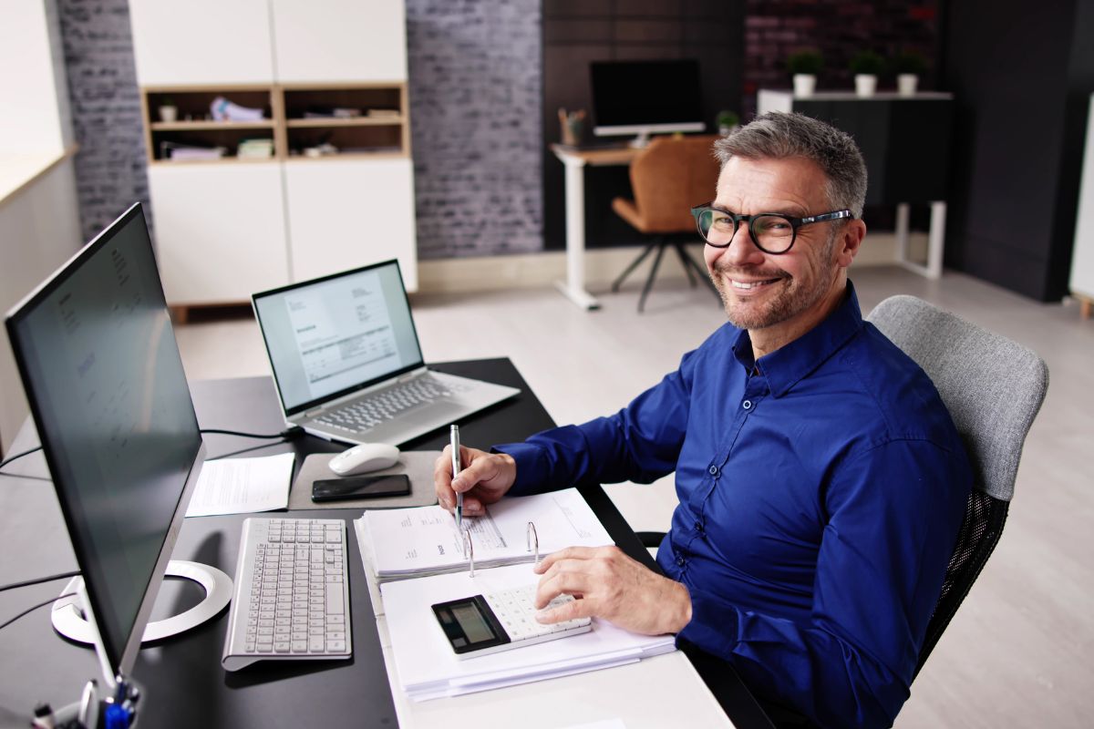 A picture of a man working on his computer as a virtual bookkeeper.
