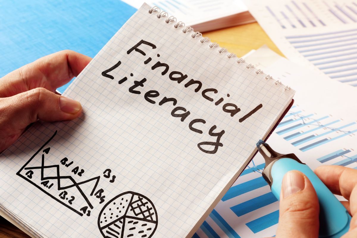 The picture shows a notebook with financial literacy wording.