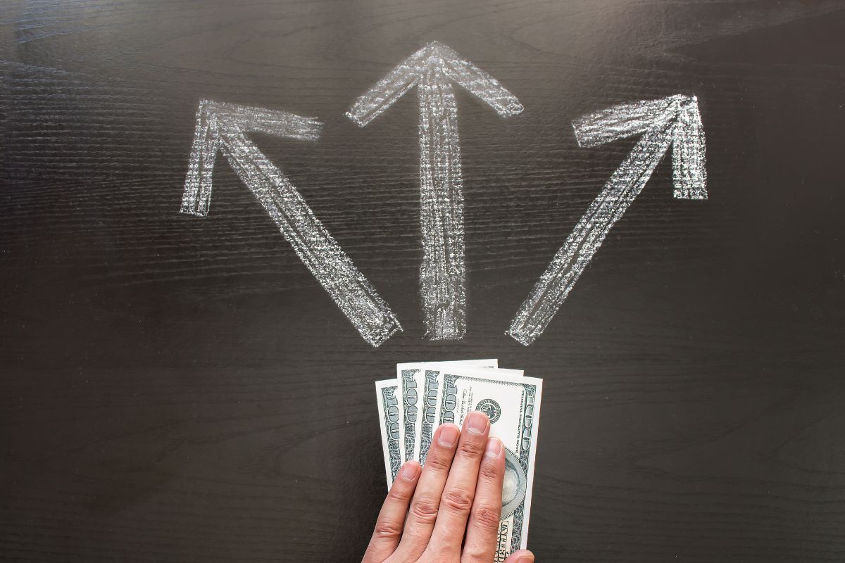 The image of a woman's hand making financial decisions.