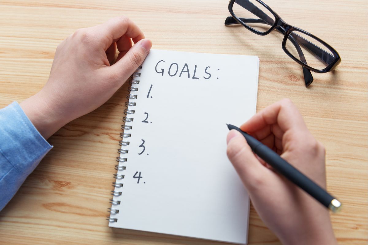 The photo of a woman's hand setting a clear goal.
