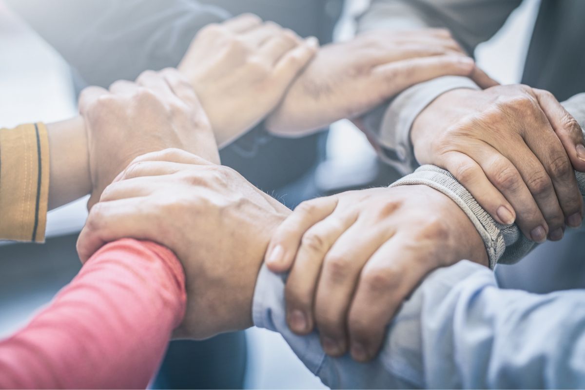 The image of joining hands together.
