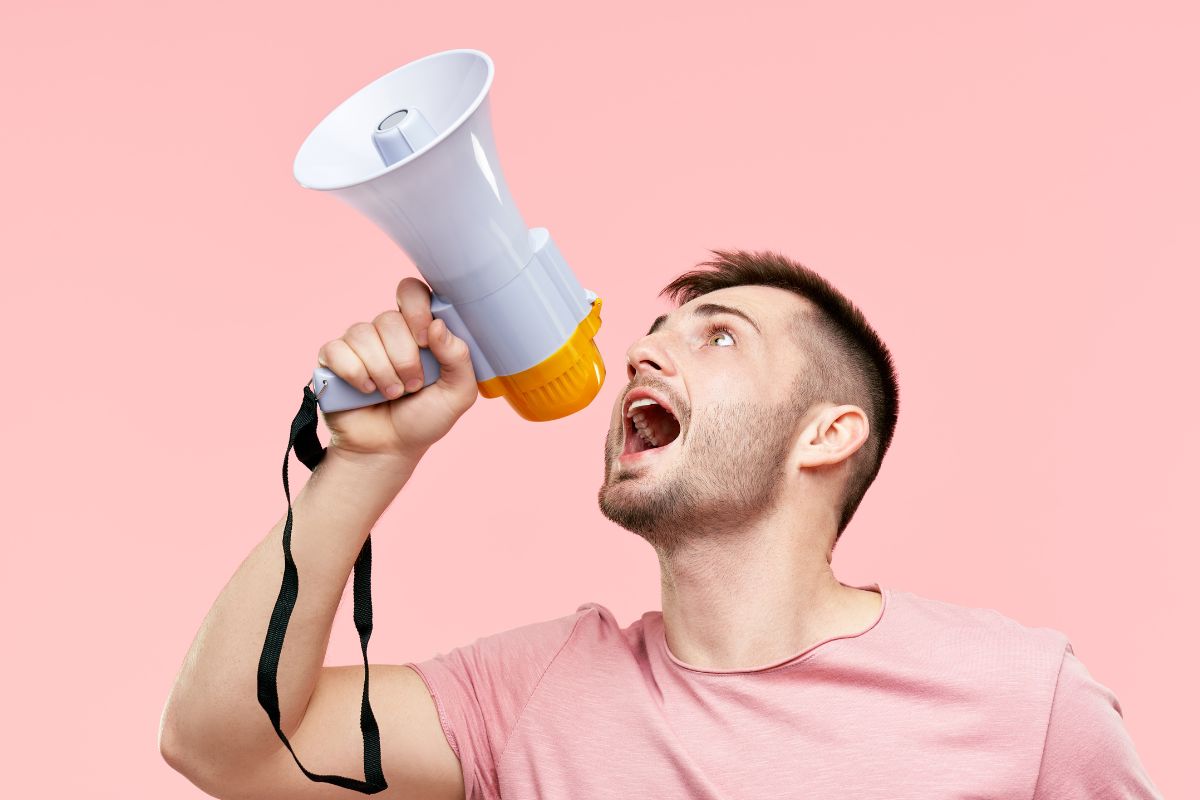 The photo shows a man speaking about his goals.