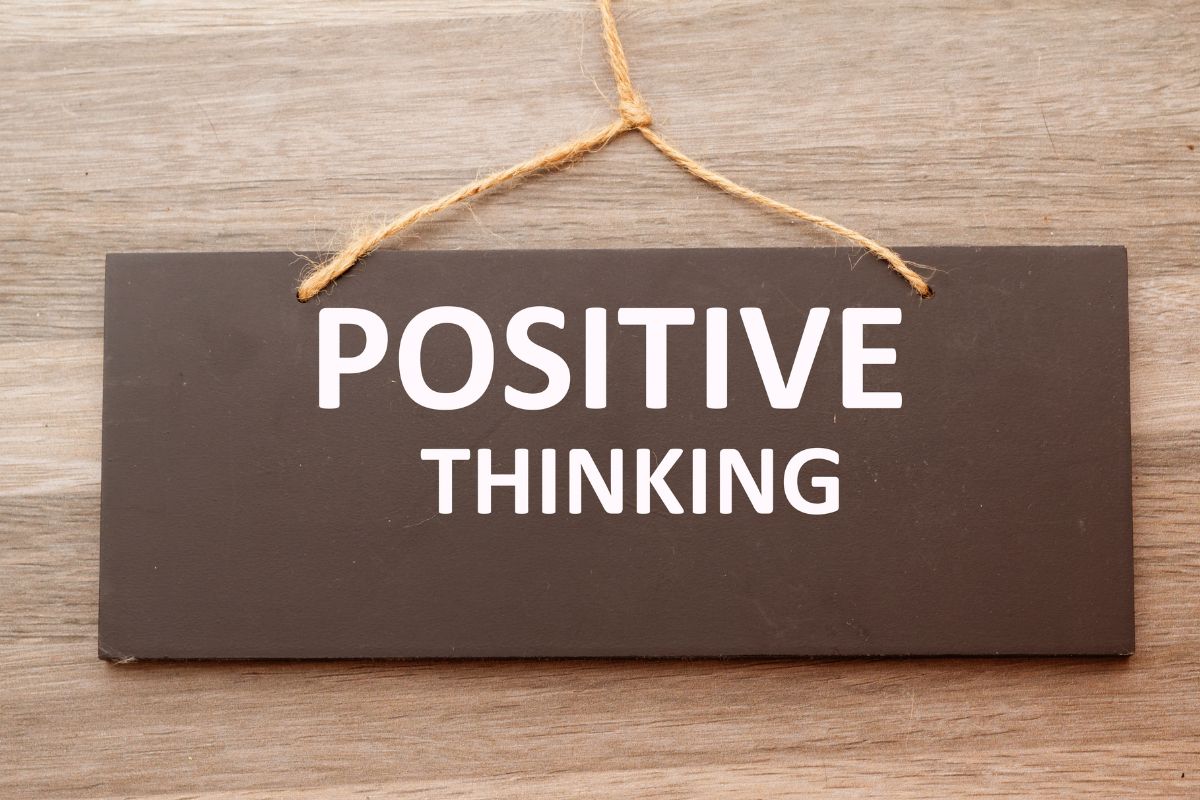 The image shows a board with notes on the wall which refers to embracing the power of positive thinking helps you stay on track when things don't go perfectly.