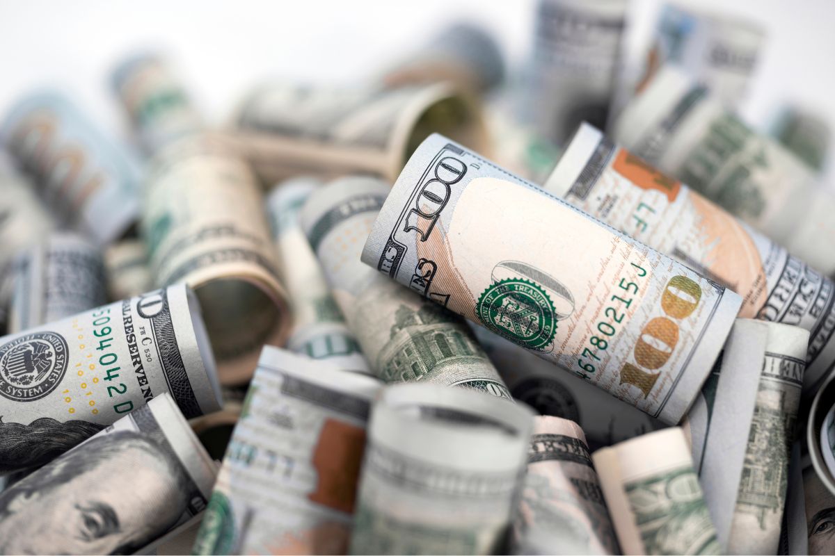 The picture shows rolled dollar bills which means affirming that financial abundance is already on its way helps you stay motivated.