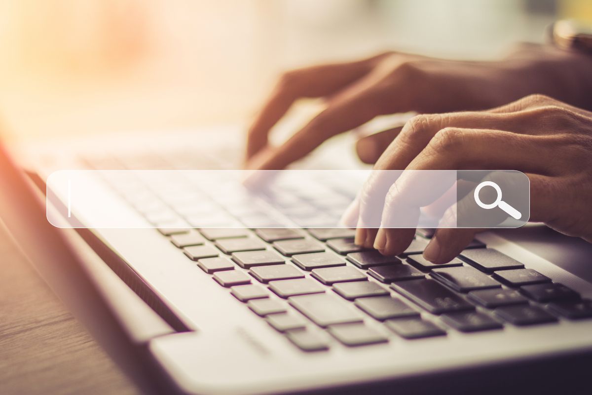 Picture of a woman's hand using a laptop. 