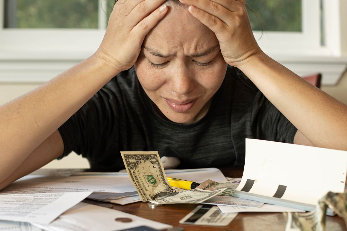 The image of a woman with financial stress.