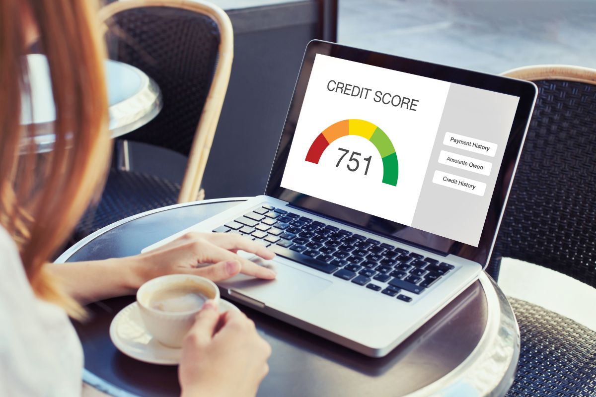 The image shows a girl using a laptop with a screen display while having a coffee referring to paying off debt increases your credit score and can help you rent a home or get a job.