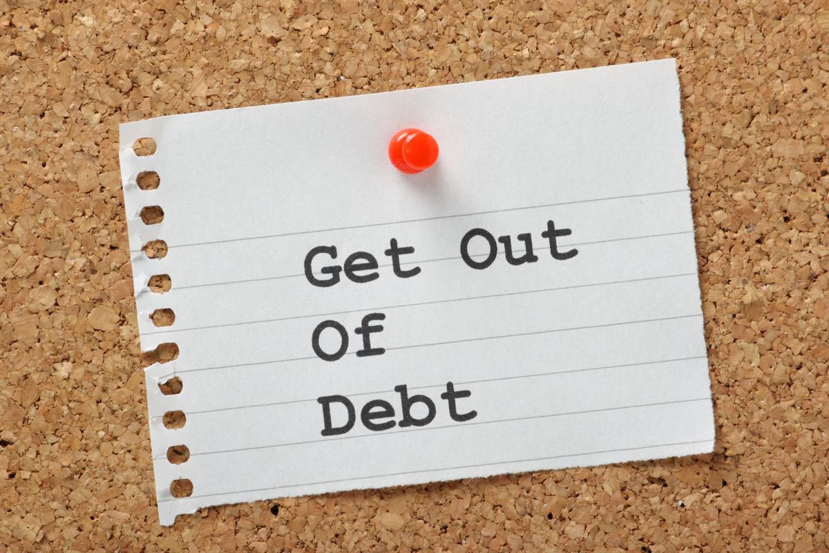 The image shows a paper with get out of debt wording.