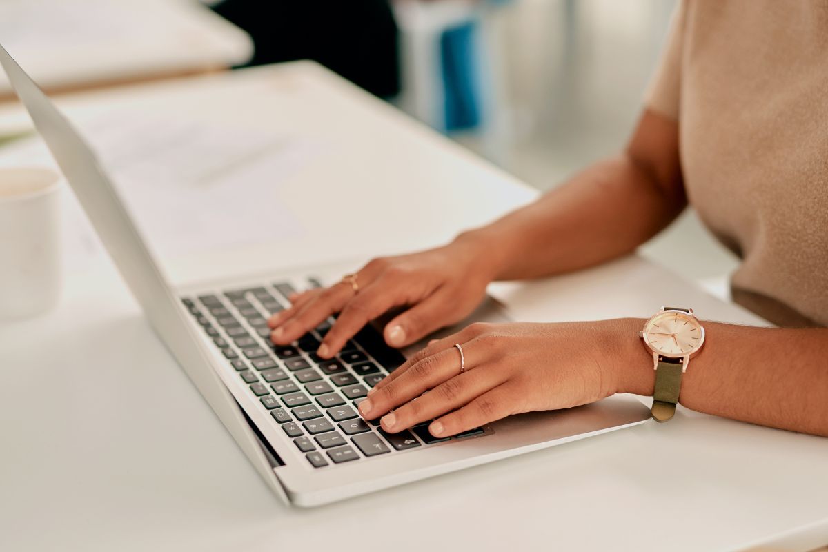 The photo shows a girl's hand using a laptop referring to being responsive and providing excellent customer service leads to repeat business and a solid reputation.