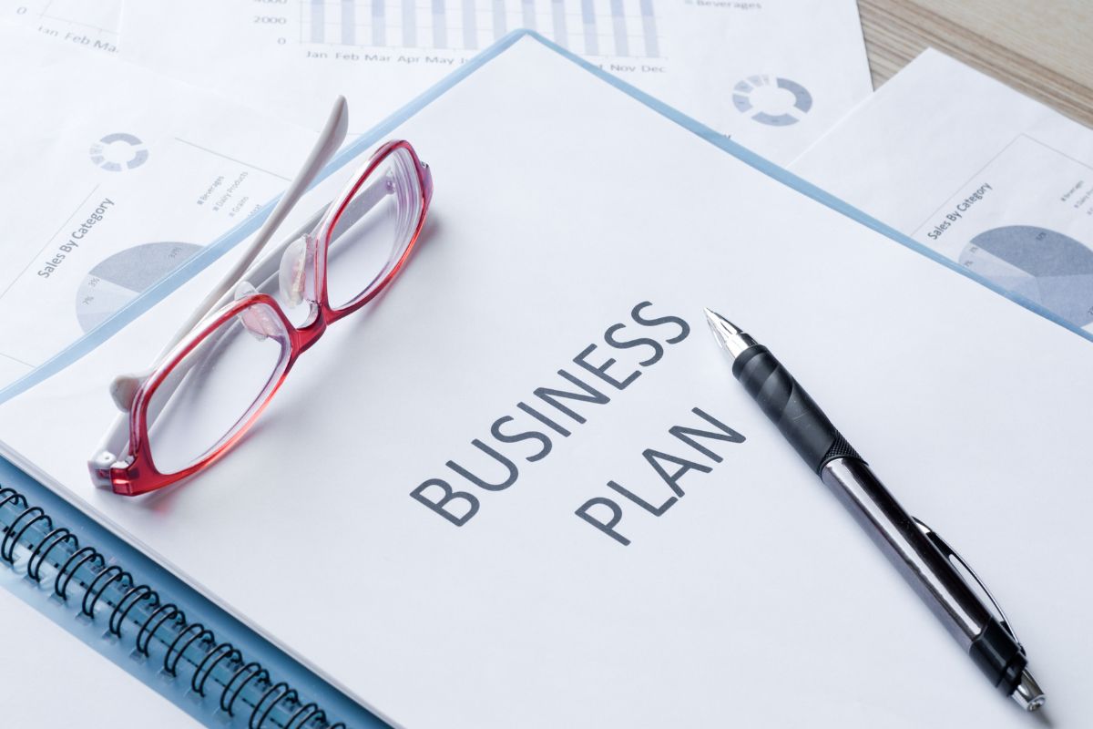The image of a notebook with a business plan written.