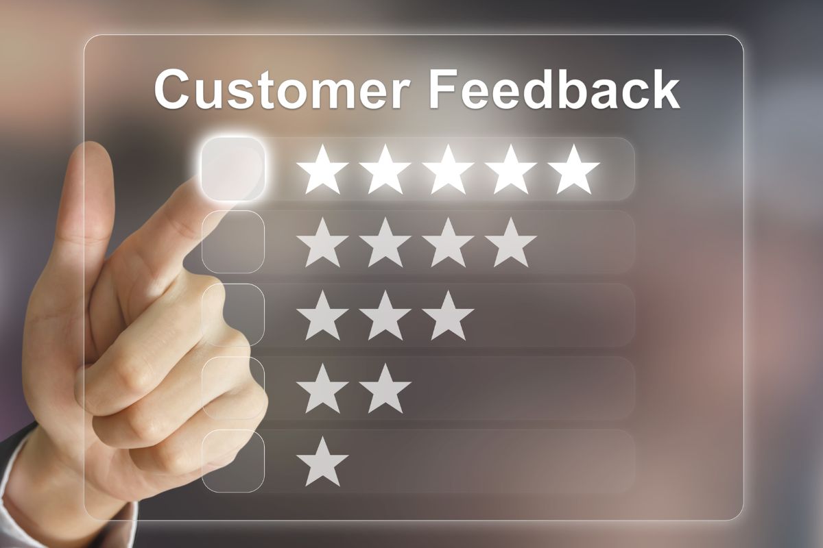 The image shows a man's hand pointing to the visual display with customer feedback and stars by level indicating that focusing on customer retention and loyalty can turn a small business into a long-term success.