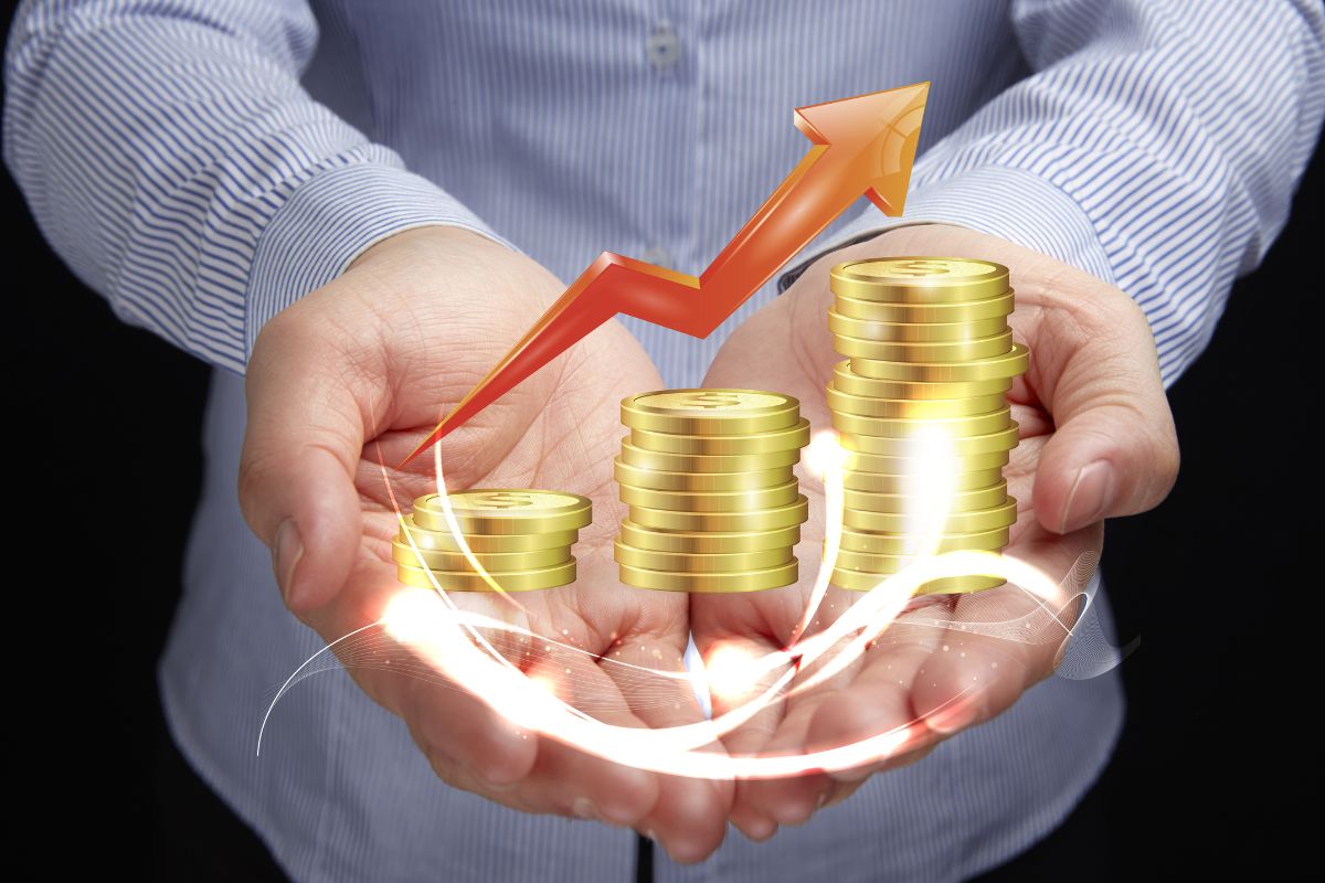 The picture shows a man's hand showing a visual coin stock and an arrow which means reinvesting profit for growth helps your business grow faster and makes it more stable.