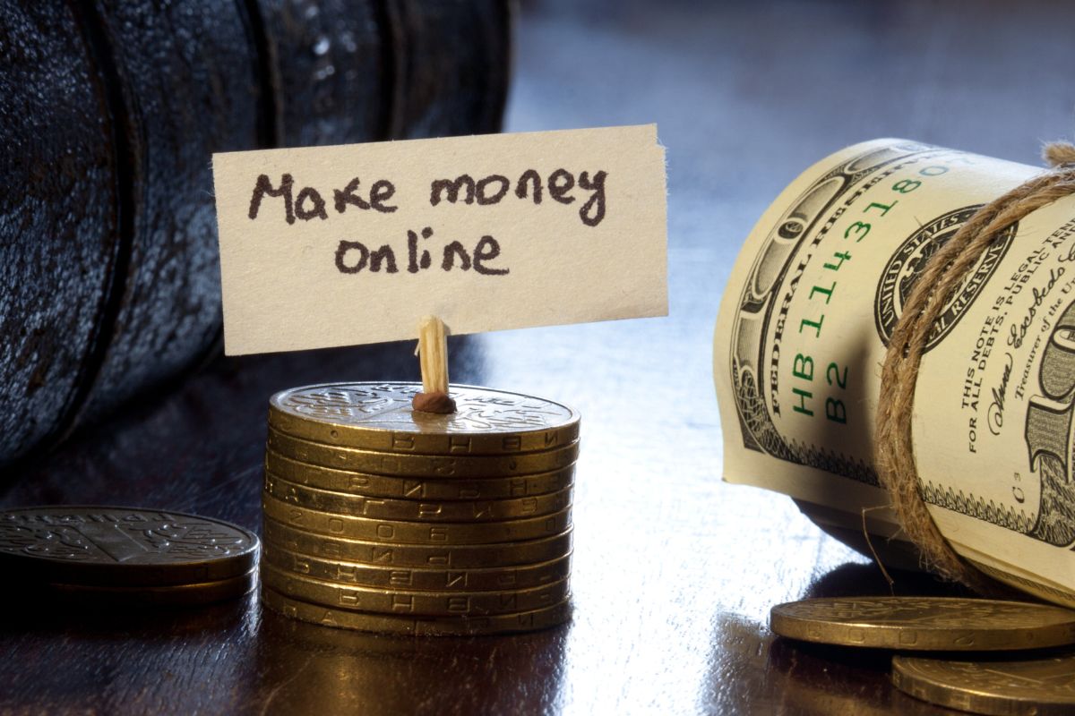 The picture tells about a coins, rolled dollar bills, and stock coins with a piece of paper with notes referring to find other ideas to make money online to help boots your earnings and create financial  freedom.