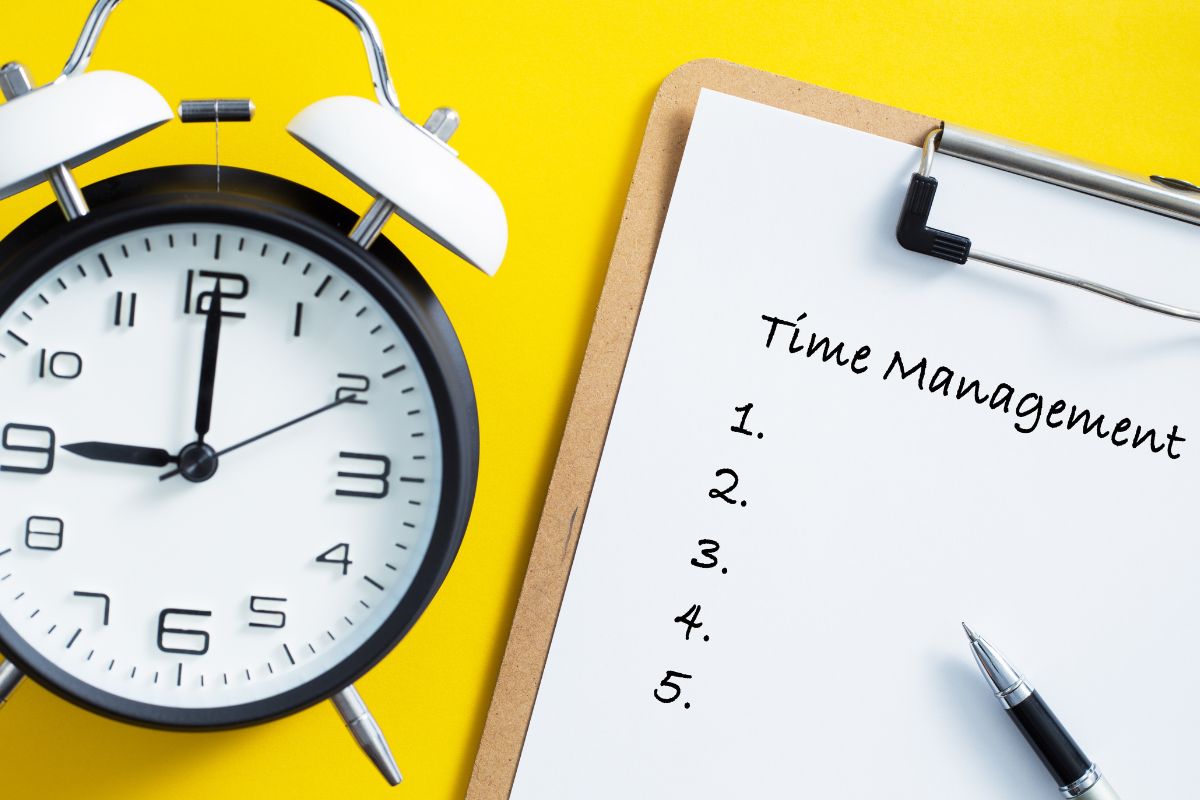 The picture shows a clock and a paper with a time management list.