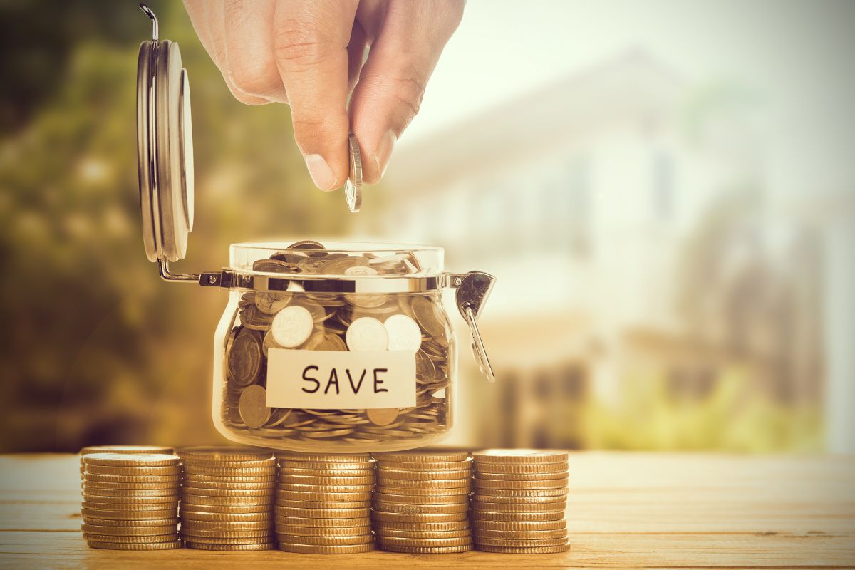 The photo shows a man saving money in a jar.