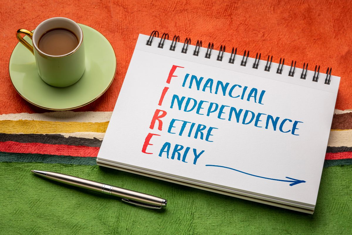 The image tells about a pen, a coffee, and a notebook with notes which refers to financial independence retire early is about having control over money instead of money controlling life.