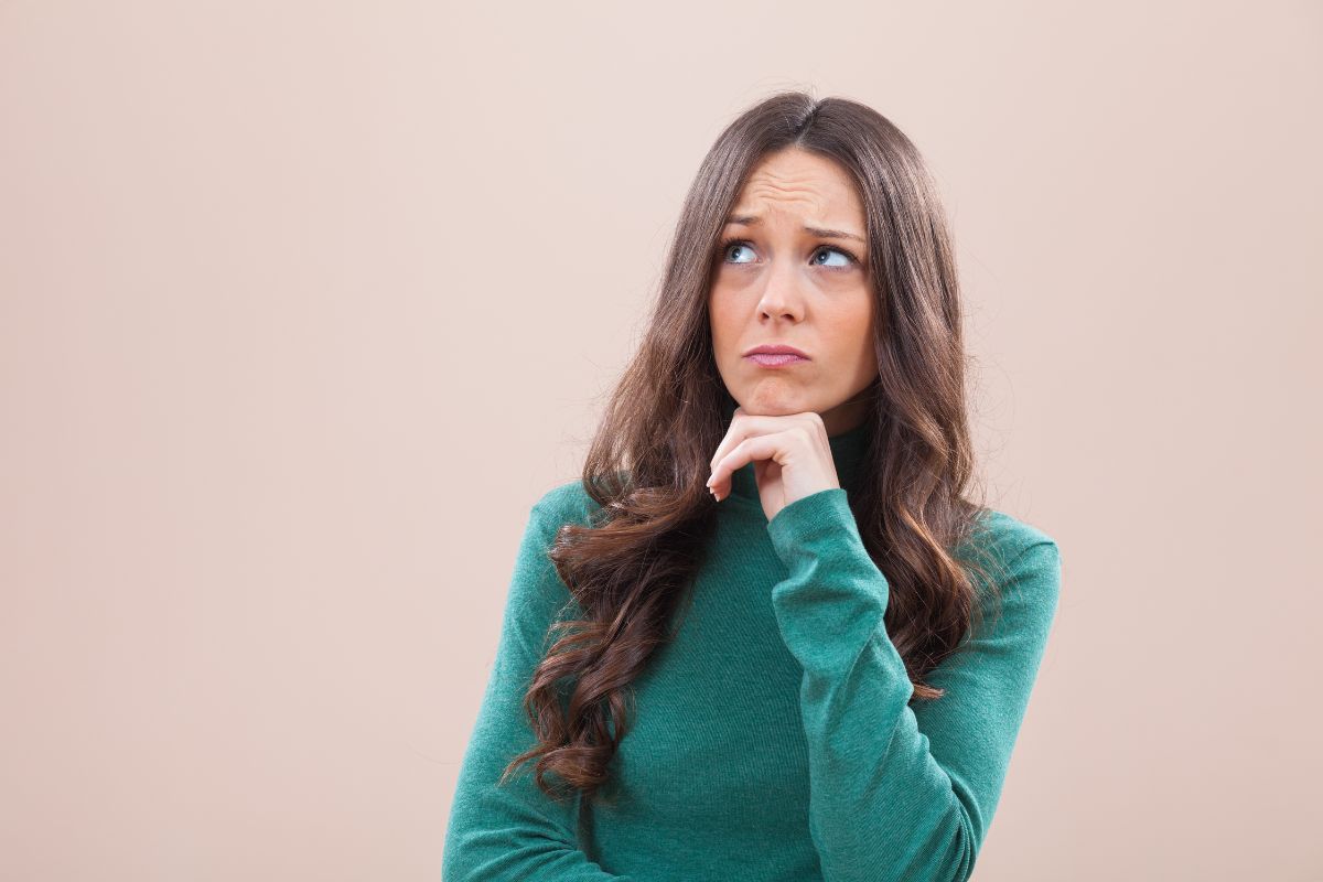 The picture tells about a girl thinking deeply which refers to asking yourself if the purchases align with your goals and can prevent regrets that lead to better financial decisions.