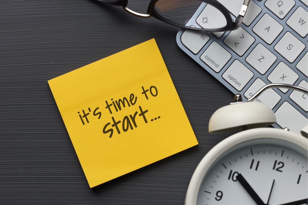 The picture tells about a keyboard, a clock, an eyeglass, and a piece of paper with notes indicating to time to make ends meet to stay on track, save money, and build financial freedom.