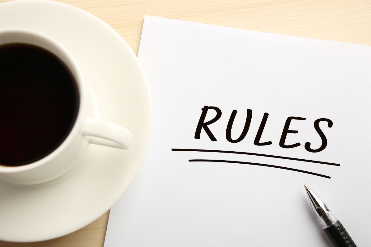 The picture shows a coffee and paper with the rules wording.