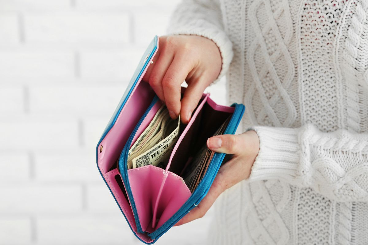 The photo shows a lady's hand trying a no-spend challenge.