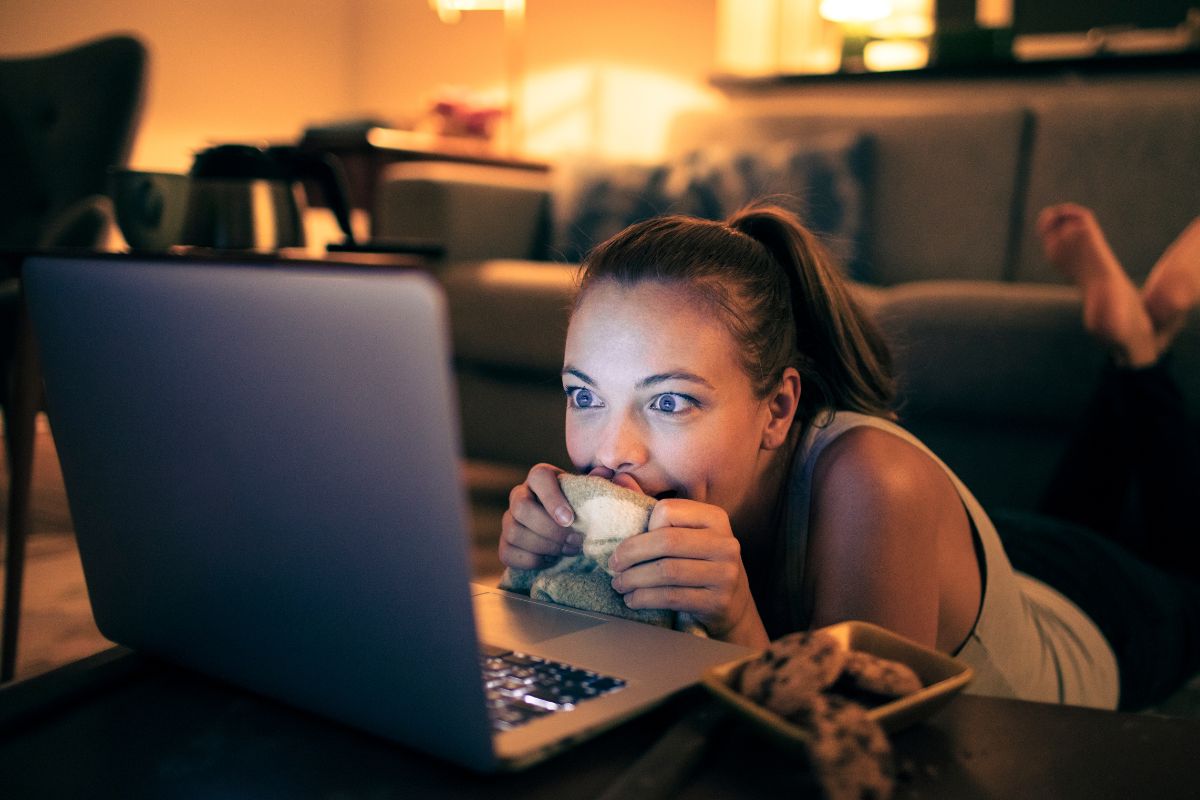 An image of a woman watching a movie as a reward for herself.