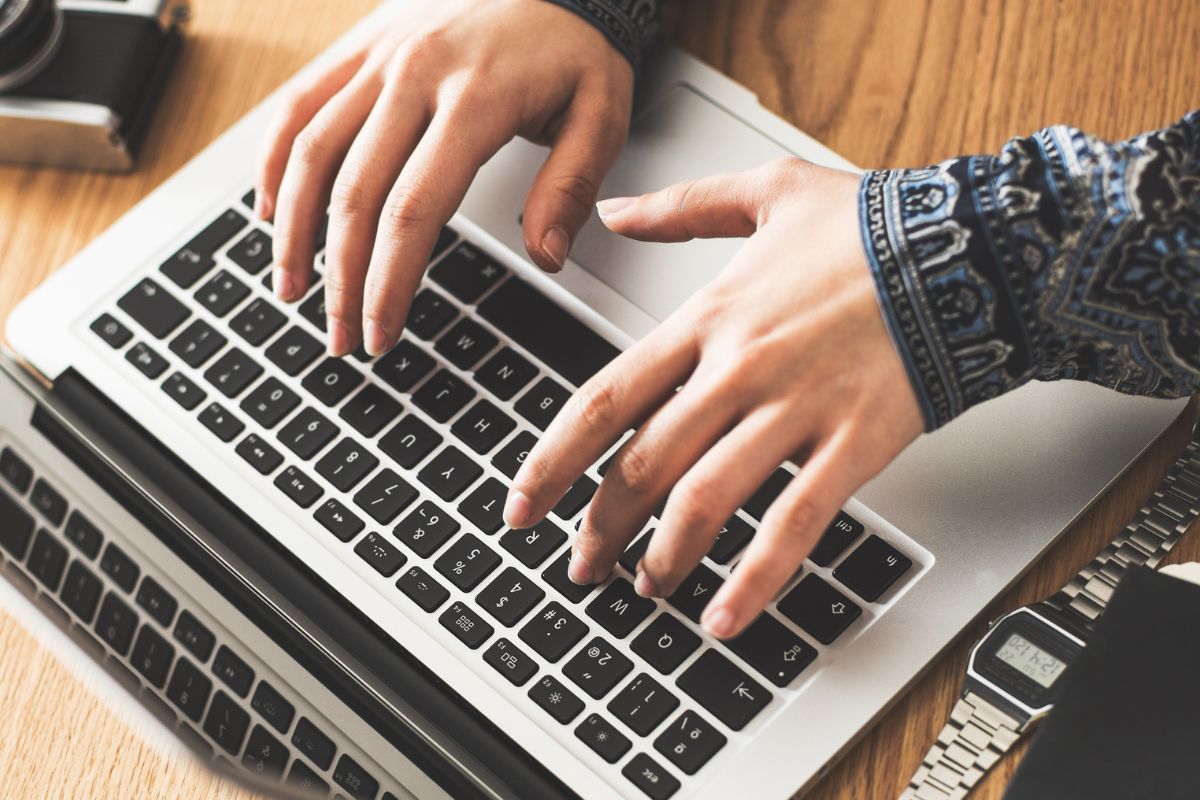 A picture of a woman's hand unsubscribing from temptations.