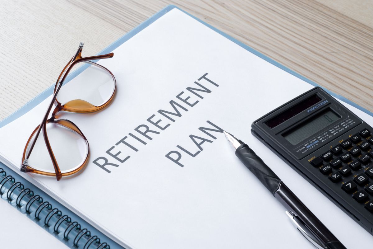 The photo is about a notebook with retirement plan wording.