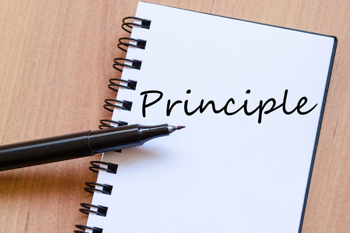 The picture shows a notebook with the principle wording.