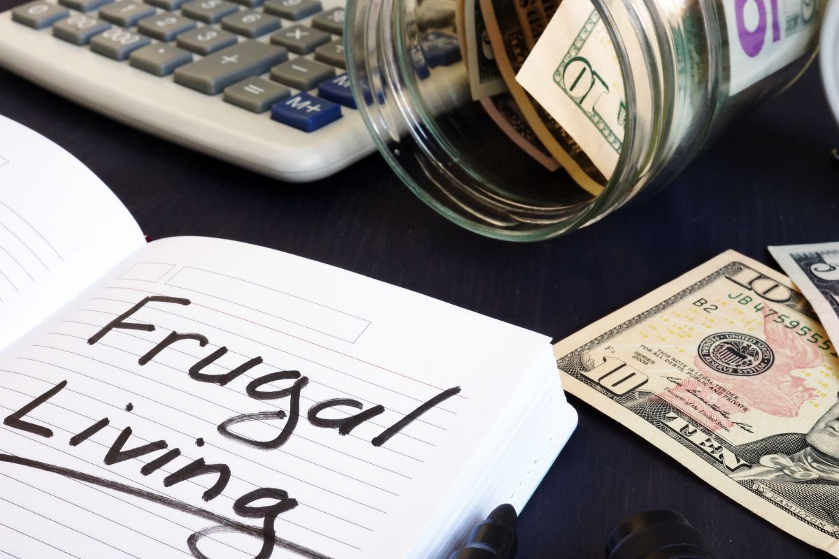 The photo shows a notebook with frugal living wording.