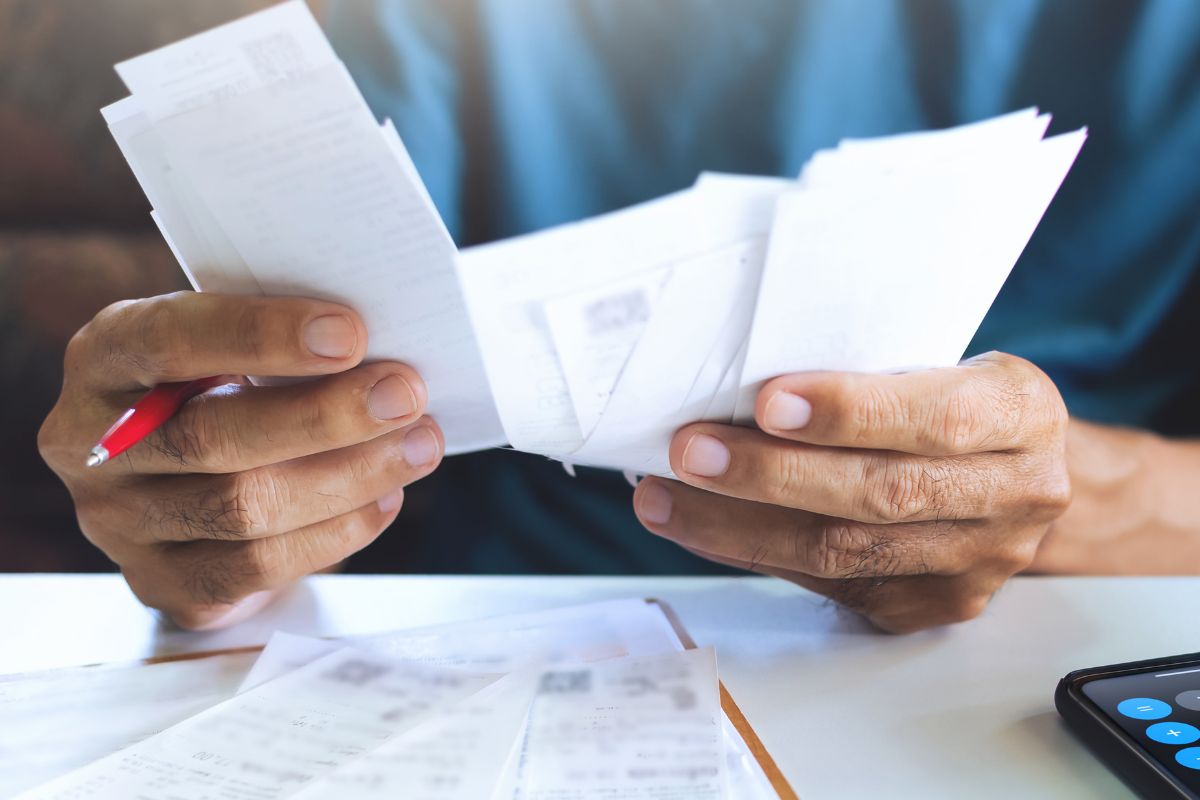 Image of a man checking his expenses. 