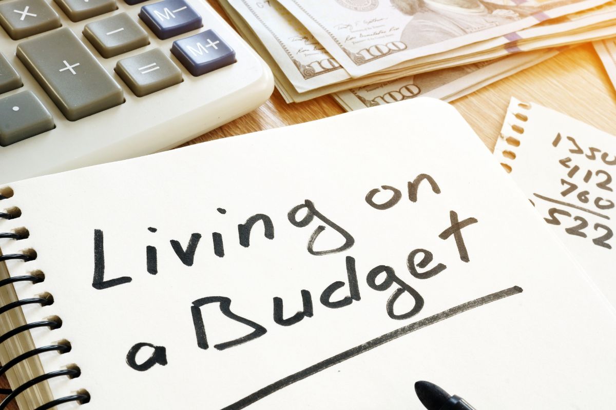 The photo is about a notebook with living on a budget written.