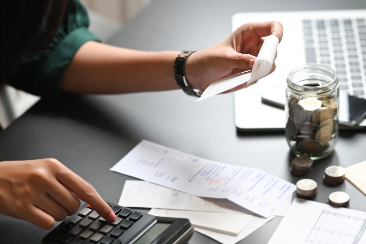 The photo shows a woman tracking her expenses.