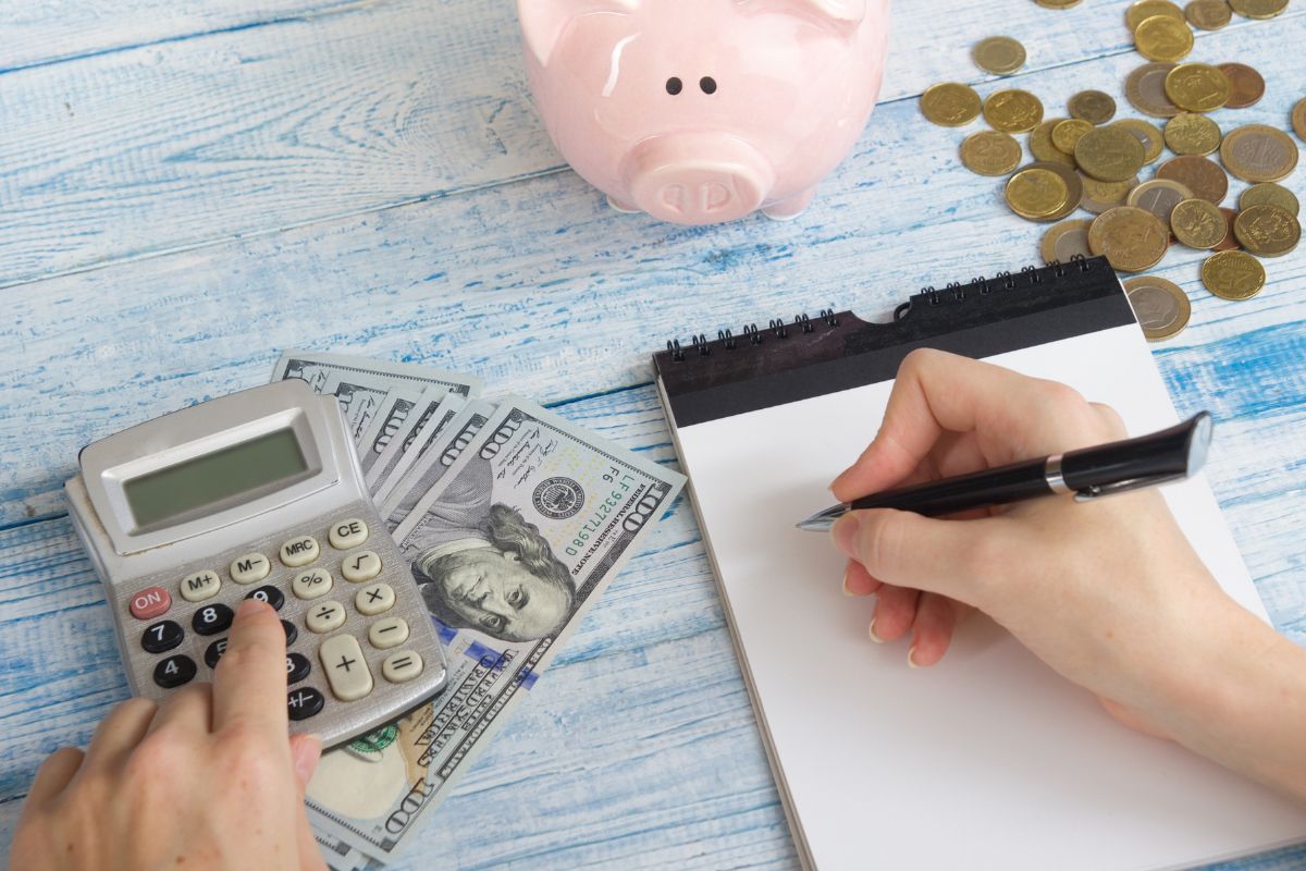 The image is about a woman's hand creating a budget.