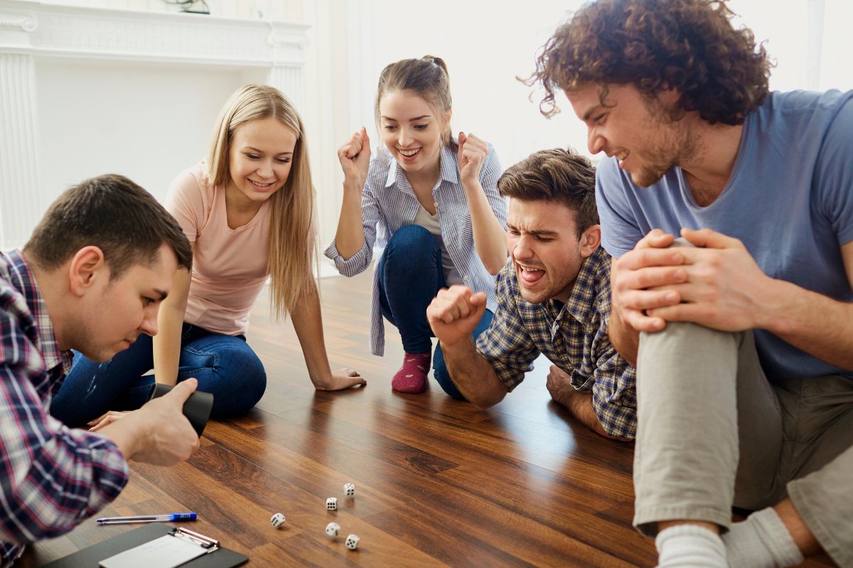 The image shows a group of friends playing games.